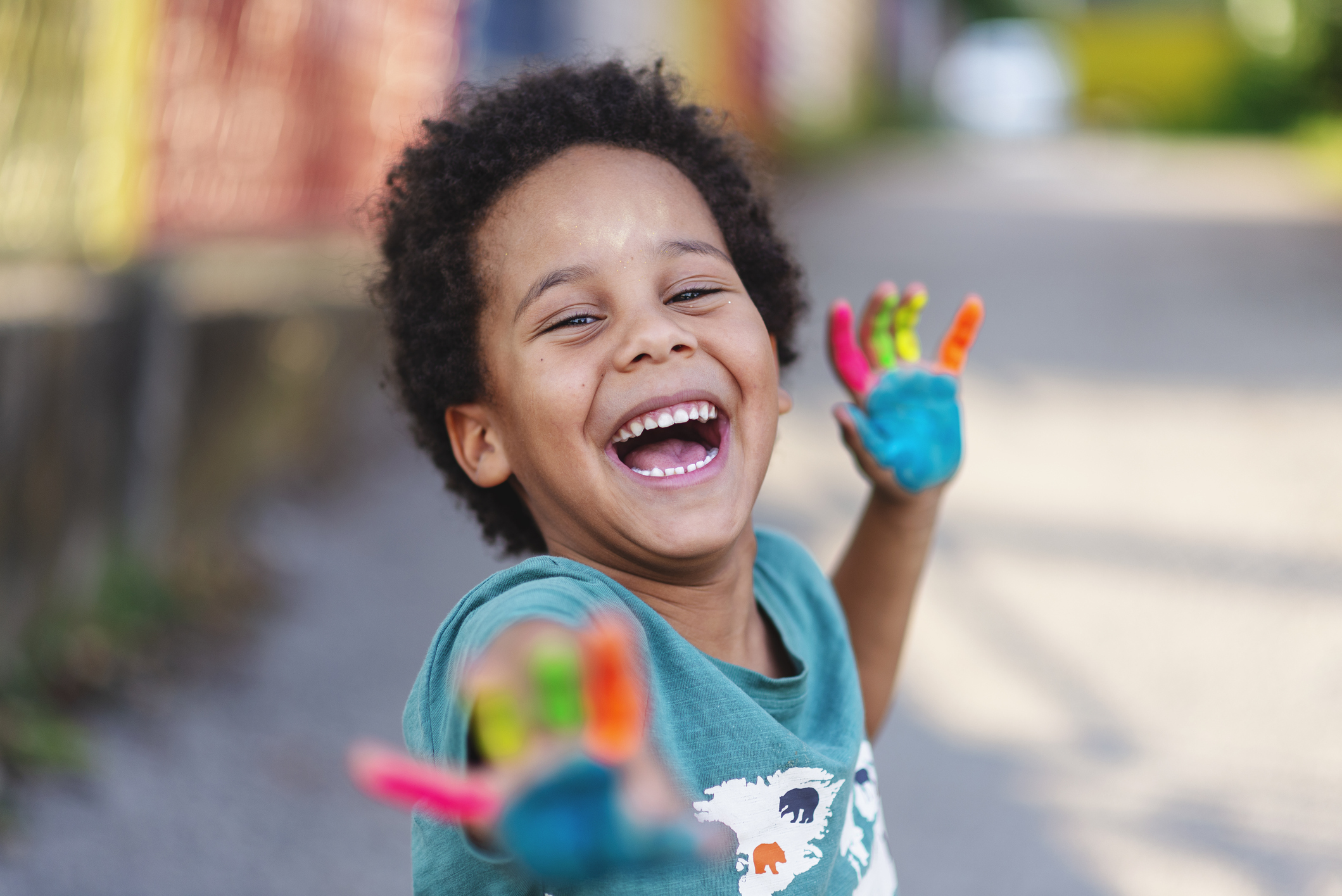 beautiful happy boy with painted hands