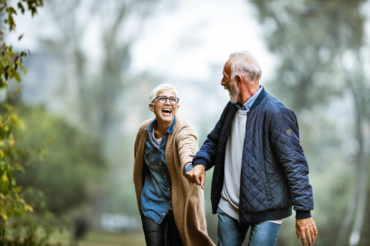 Playful senior couple having fun in the park.