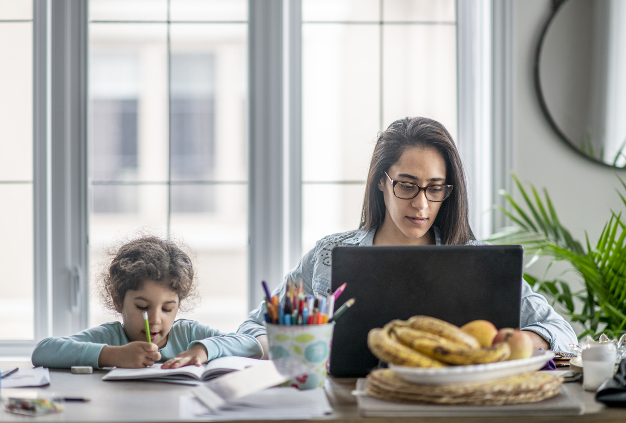 Mother and daughter working from home.