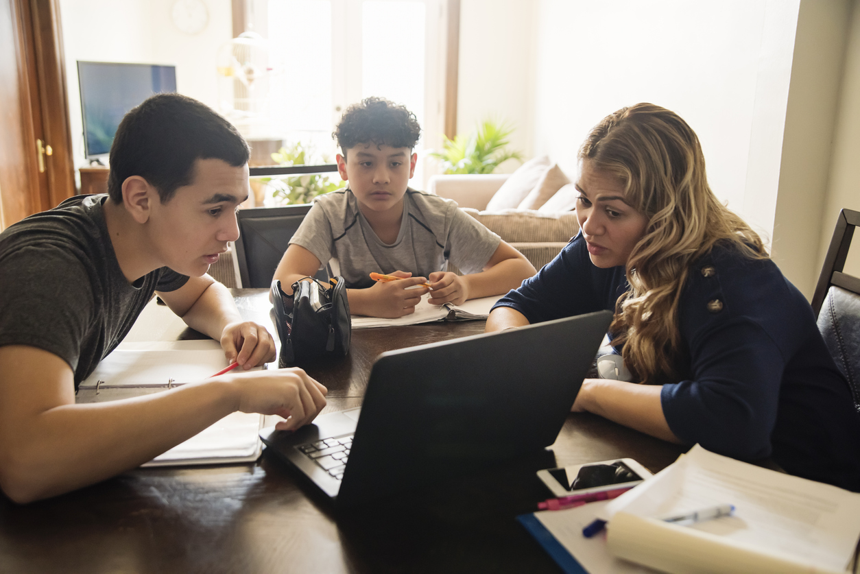 Mother homeschooling teenage boys in self-isolation, Covid-19.