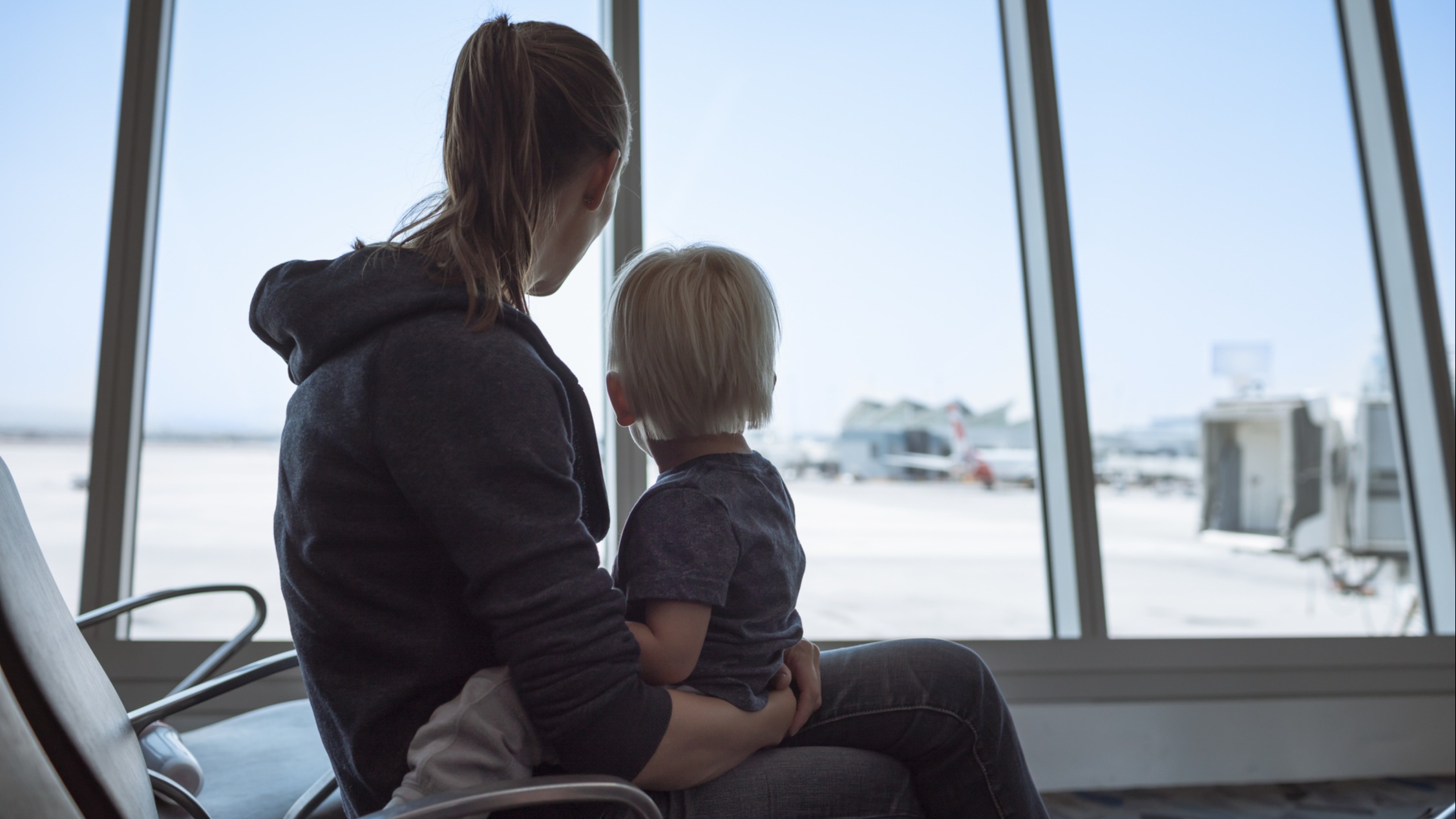 Mom traveling with child iStock-1217874678