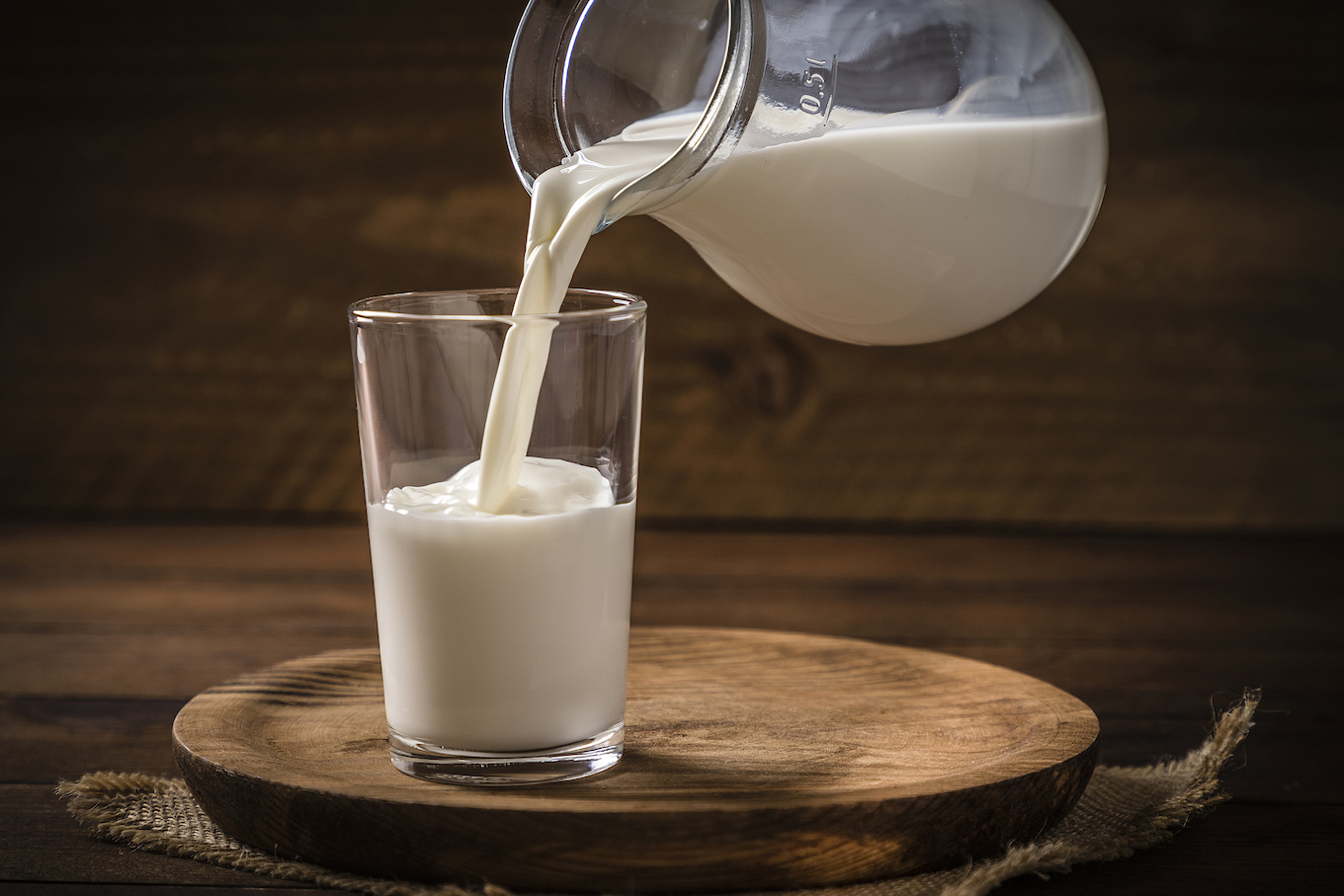 Pouring milk into a drinking glass