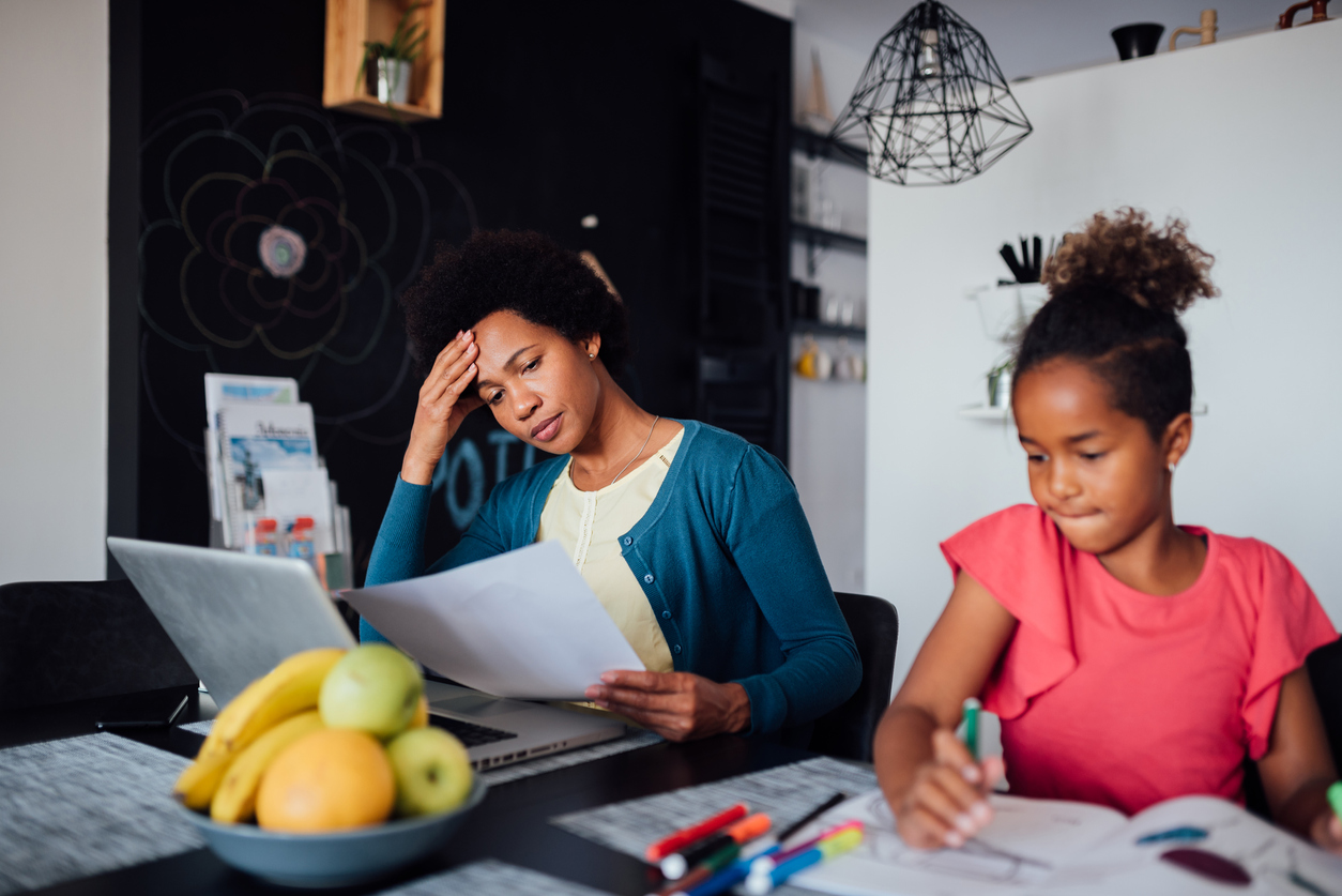 Young African American mother looking for a job using internet