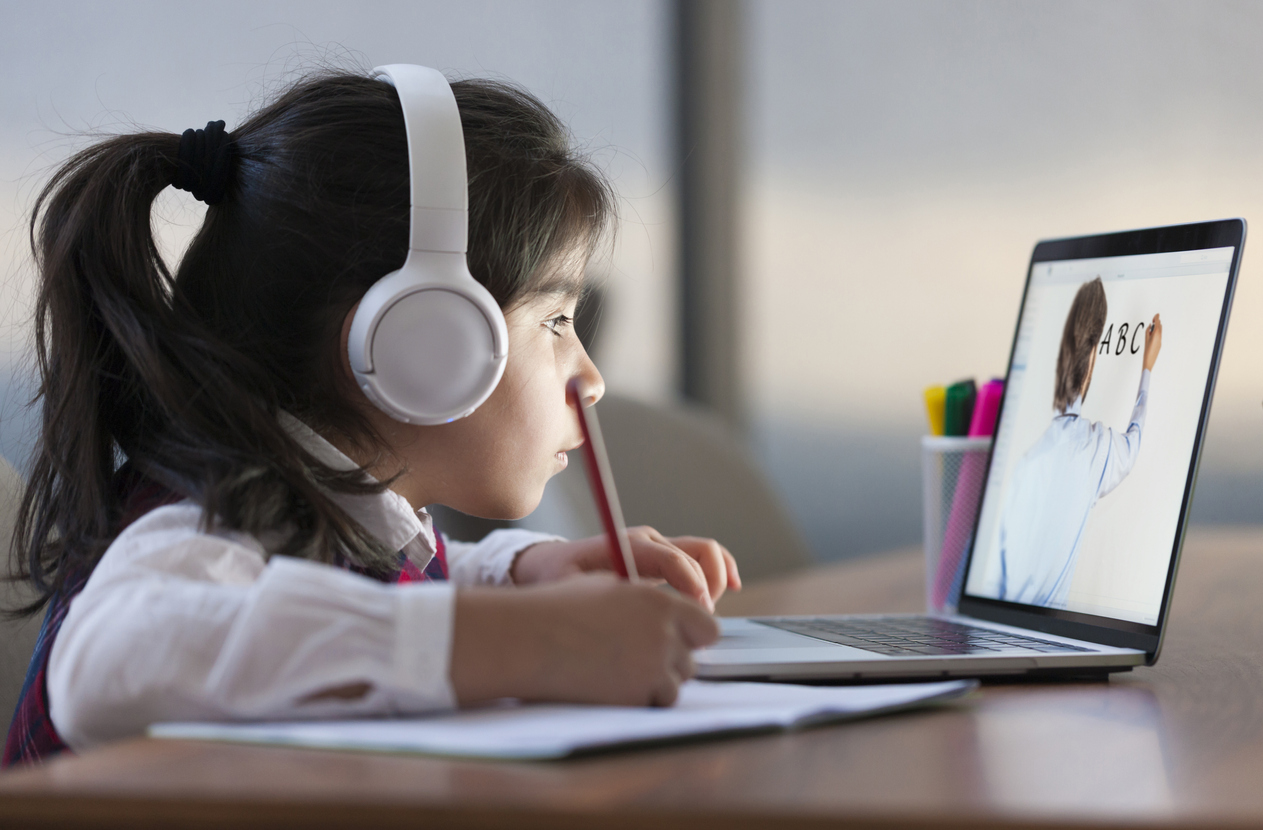 Little girl attending to online school class