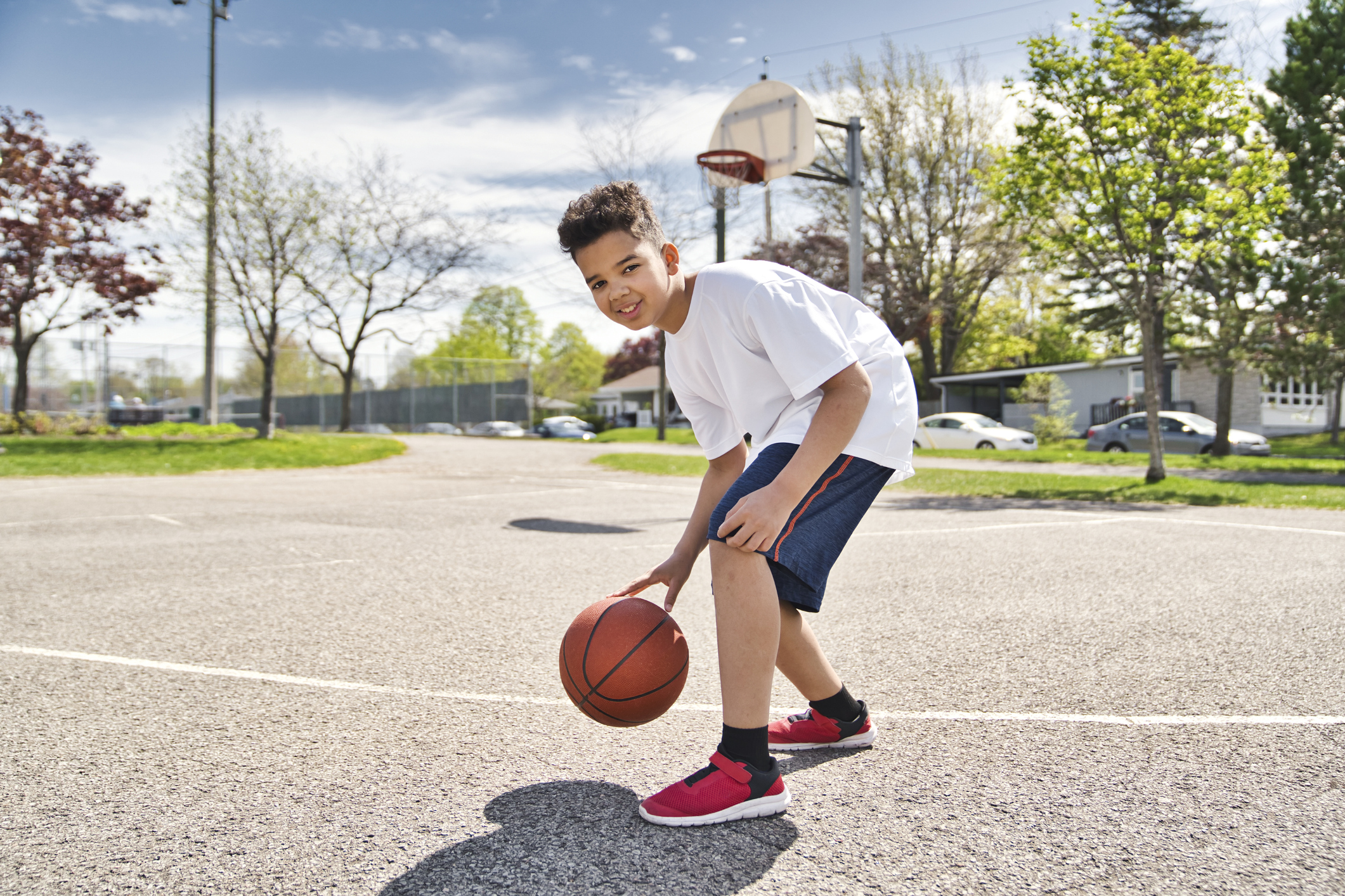 cute Afro american players playing basketball outdoors