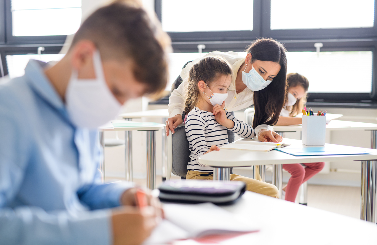 Group of children with face mask back at school after covid-19 quarantine and lockdown.