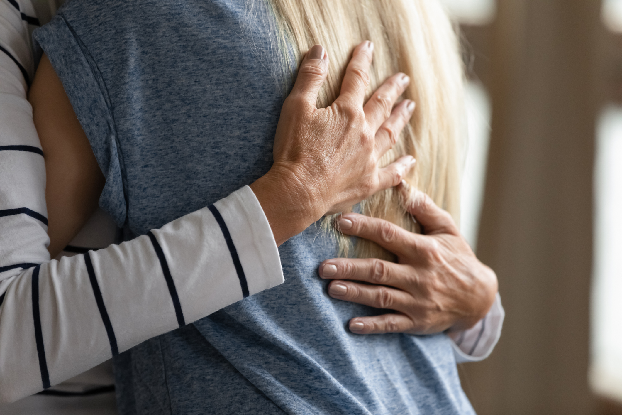 Close up cropped image elderly mother hugs grownup daughter