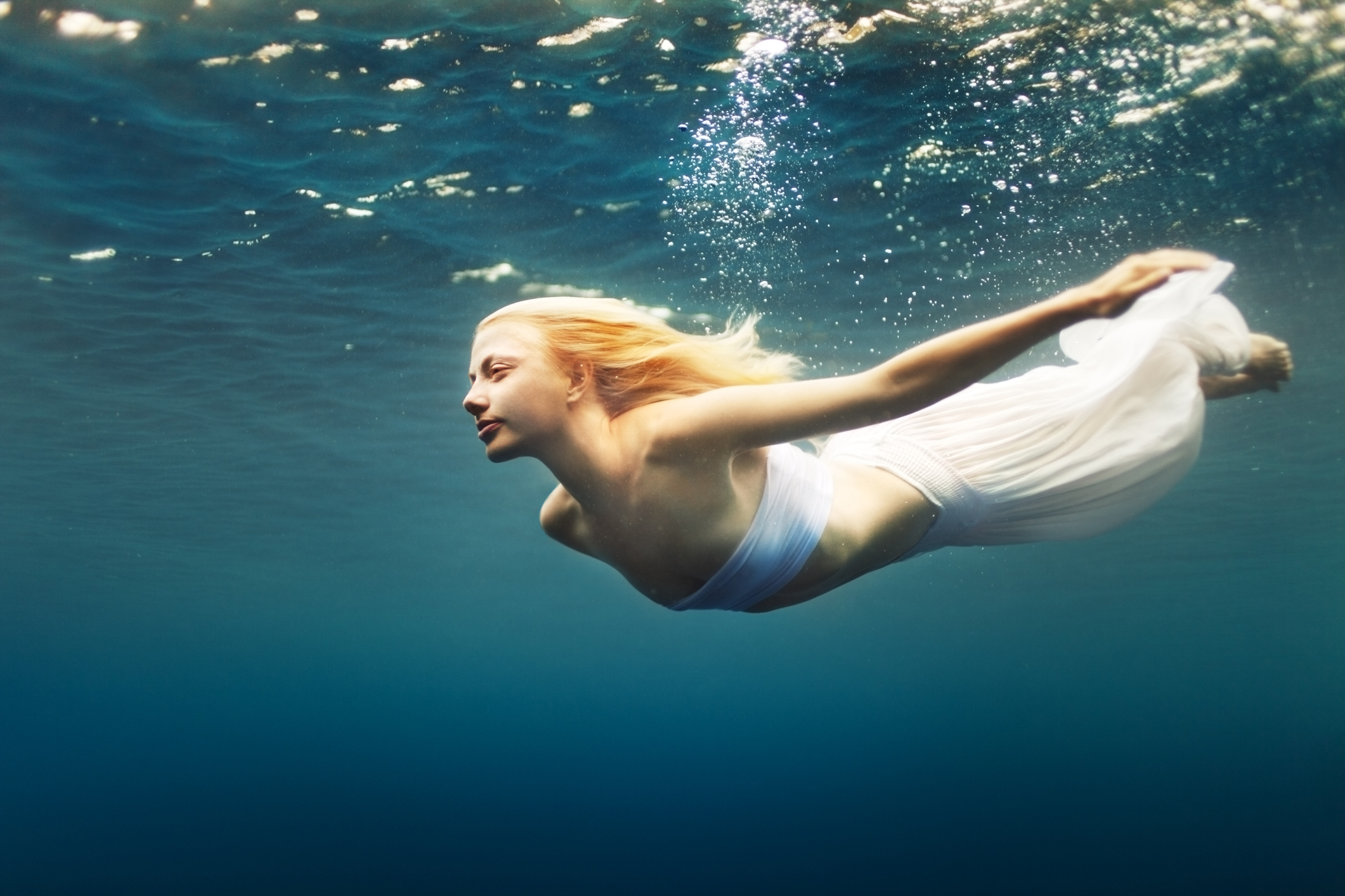 Young woman dive into deep water