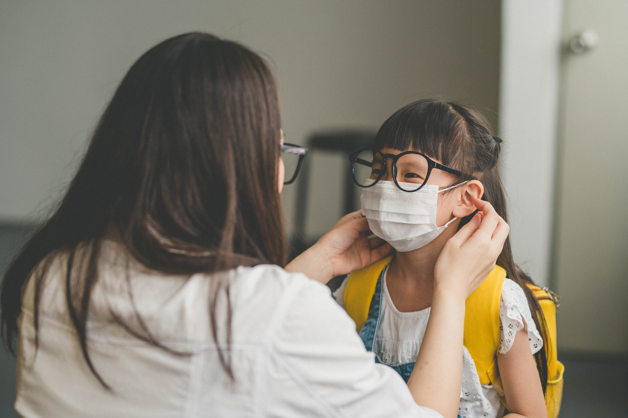 Asian mother help her daughter wearing face mask for protection Coronavirus outbreak