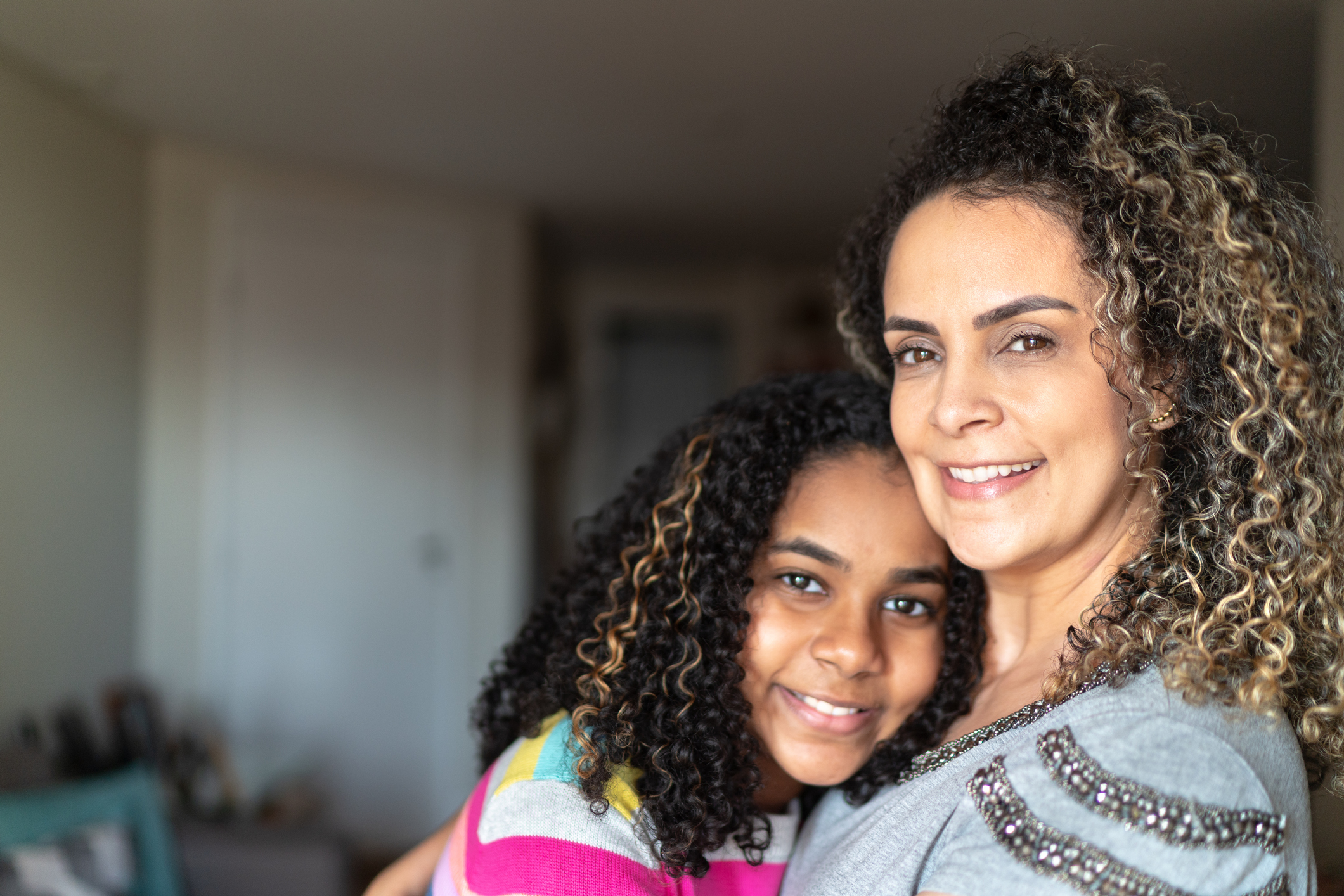 Portrait of mother and daughter embracing