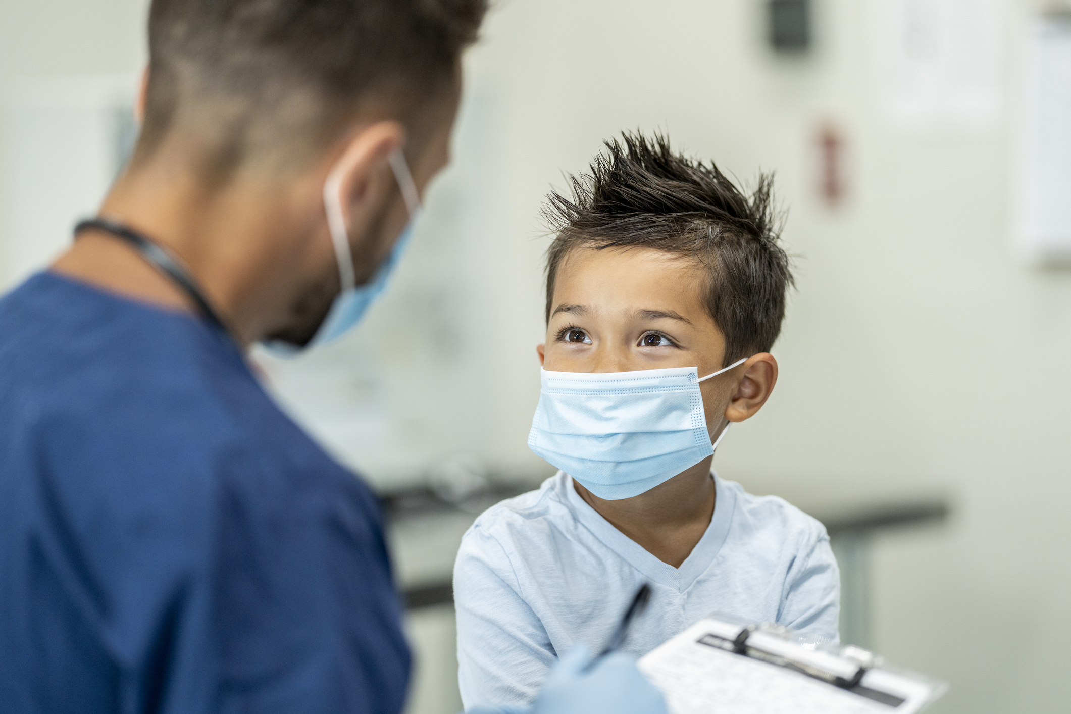 Young boy wearing a mask at a doctors appointment