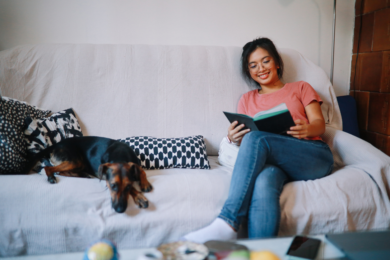 Girl reading a book on the sofa