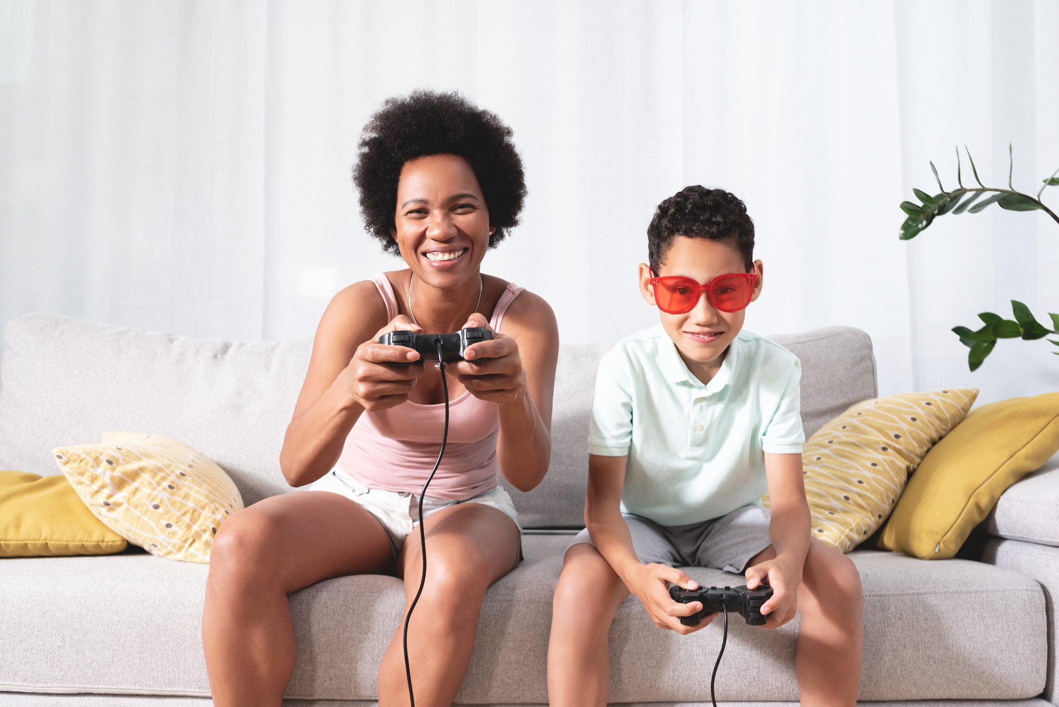 Woman playing video game with son