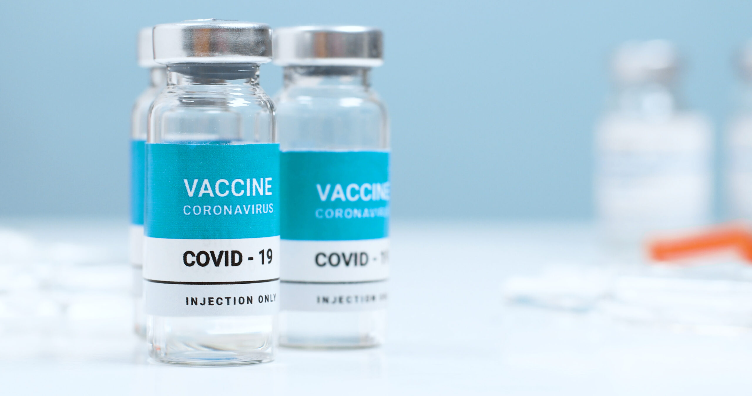 Measles, flu, coronavirus, covid 19 vaccine transparent liquid vials in the laboratory. Testing and creating a new vaccine against the epidemic