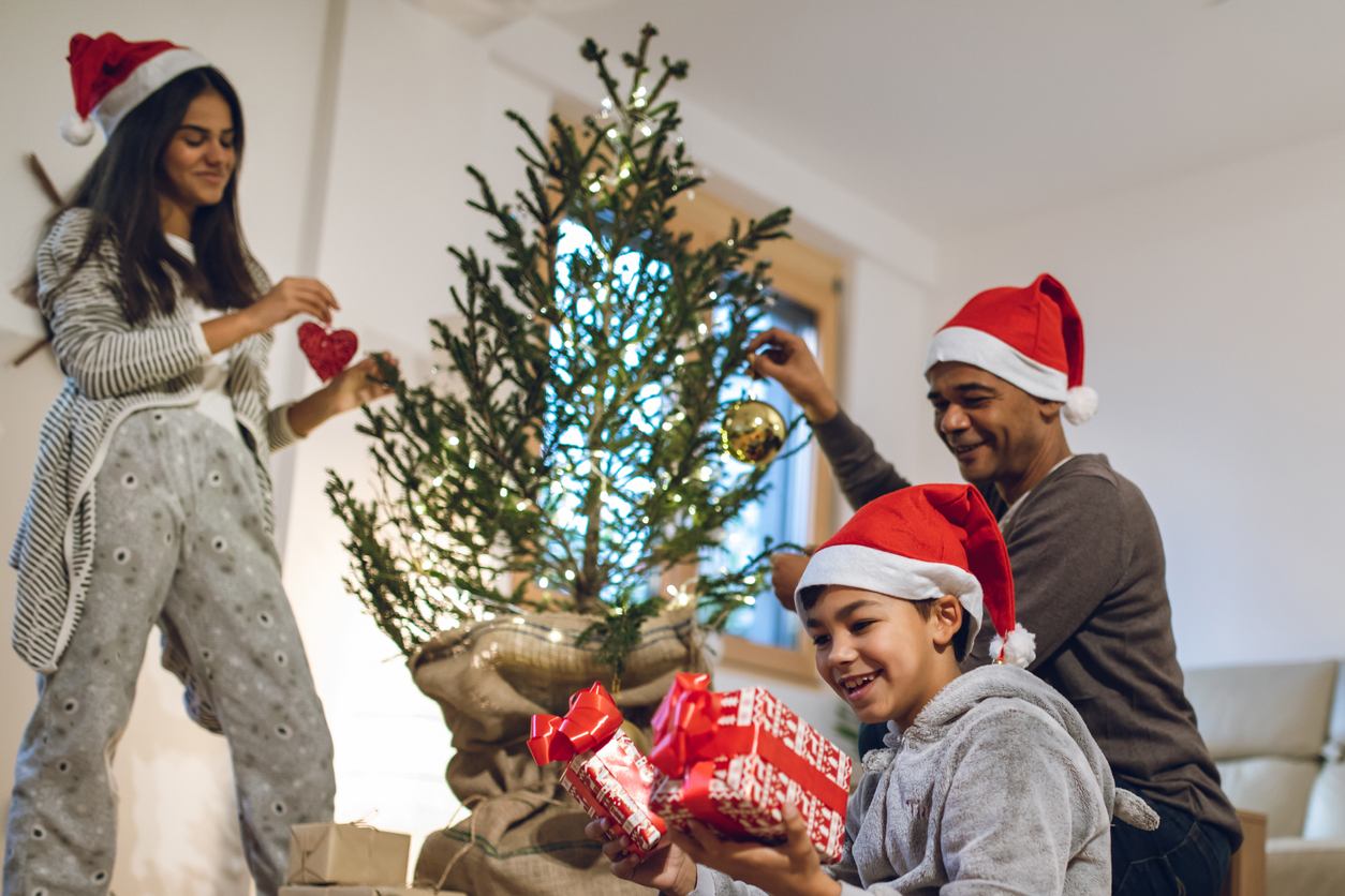 Happy family decorating Christmas tree