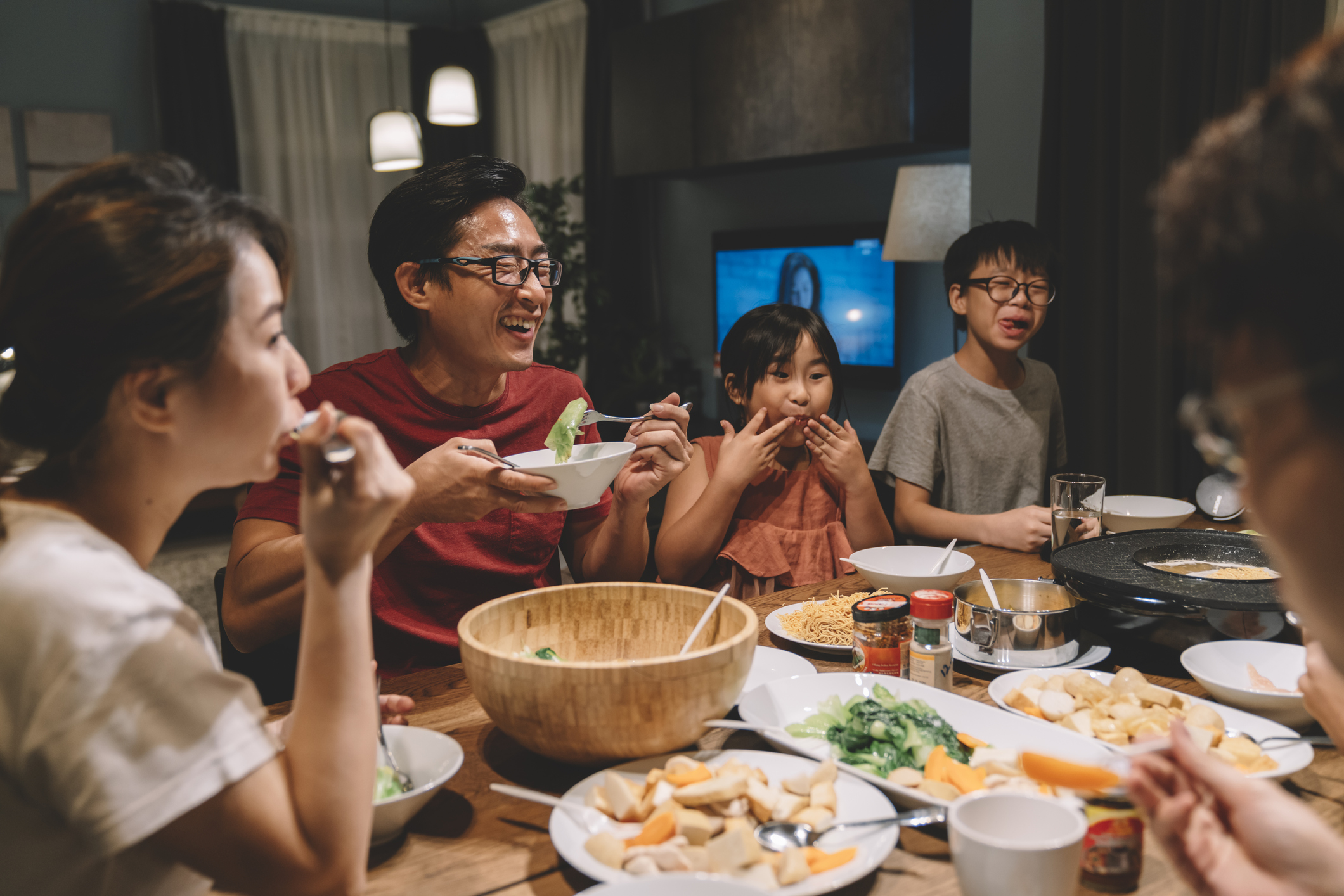 asian chinese family and cousins having reunion dinner at home