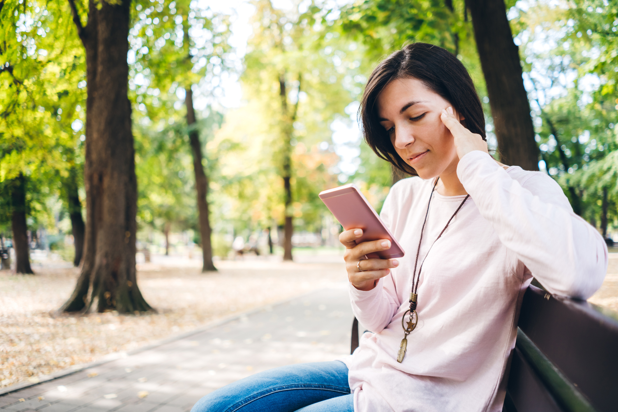 Sad woman checking reading phone message