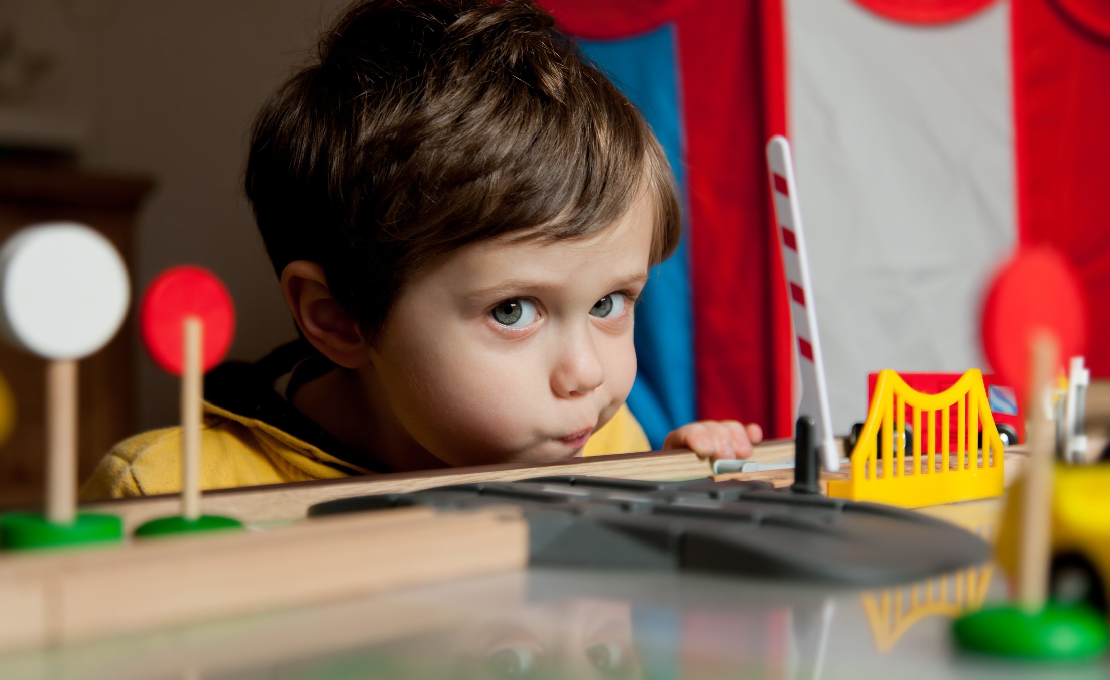 Little toddler boy play in trains at home