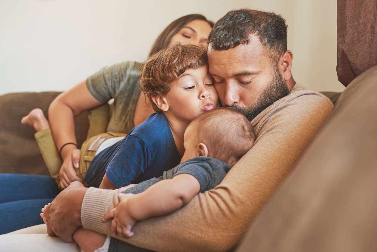 Shot of an adorable baby boy relaxing on the sofa with his family at home