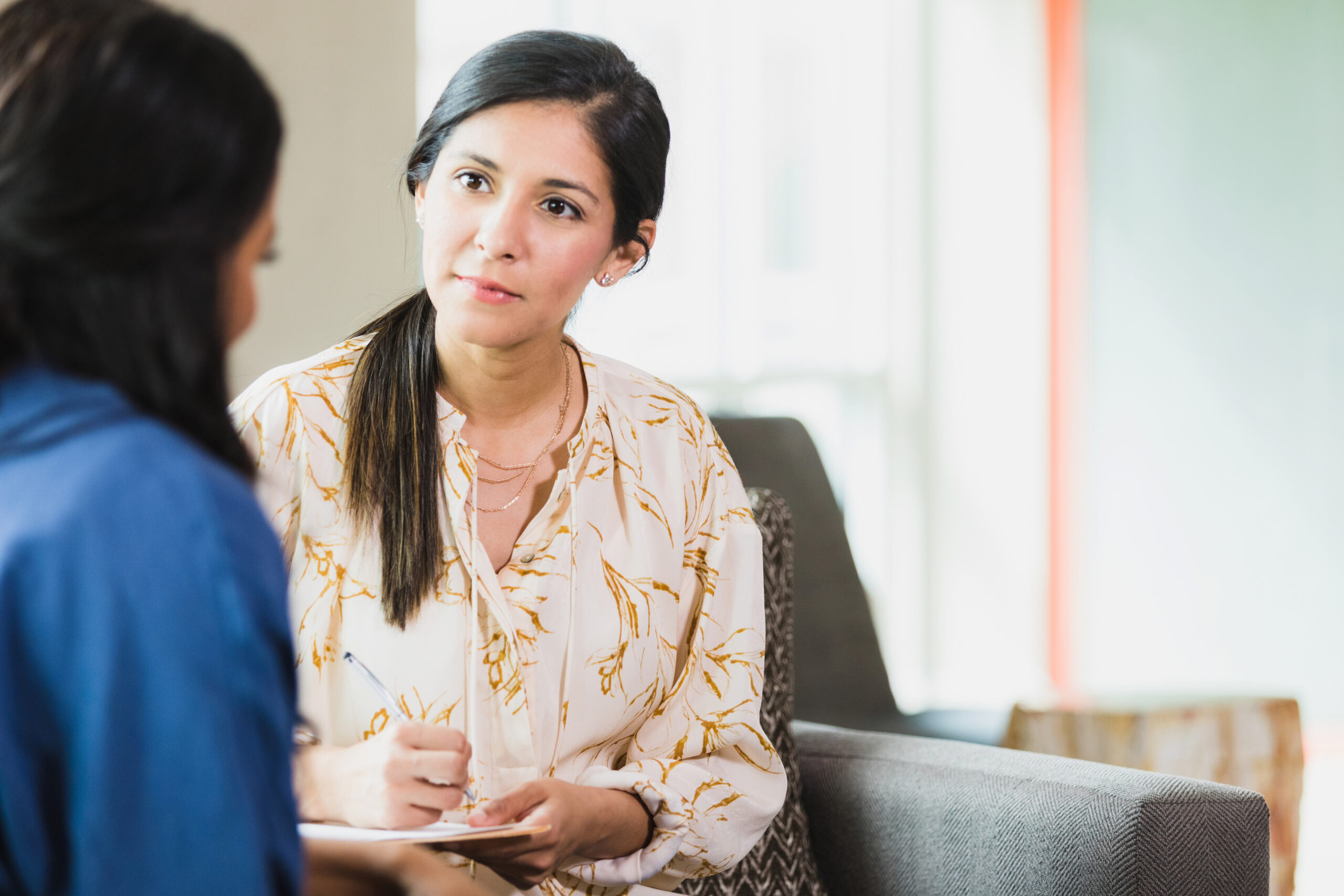 Caring counselor listening to female patient