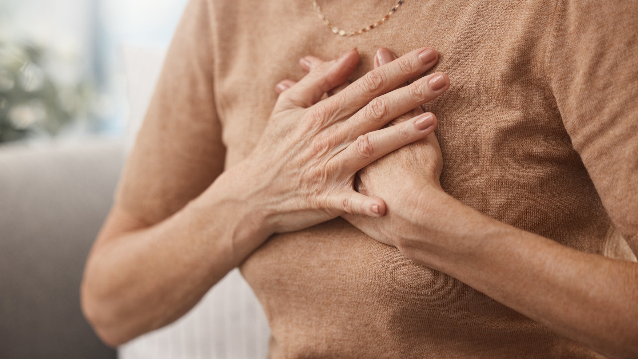 Elderly woman holding her chest