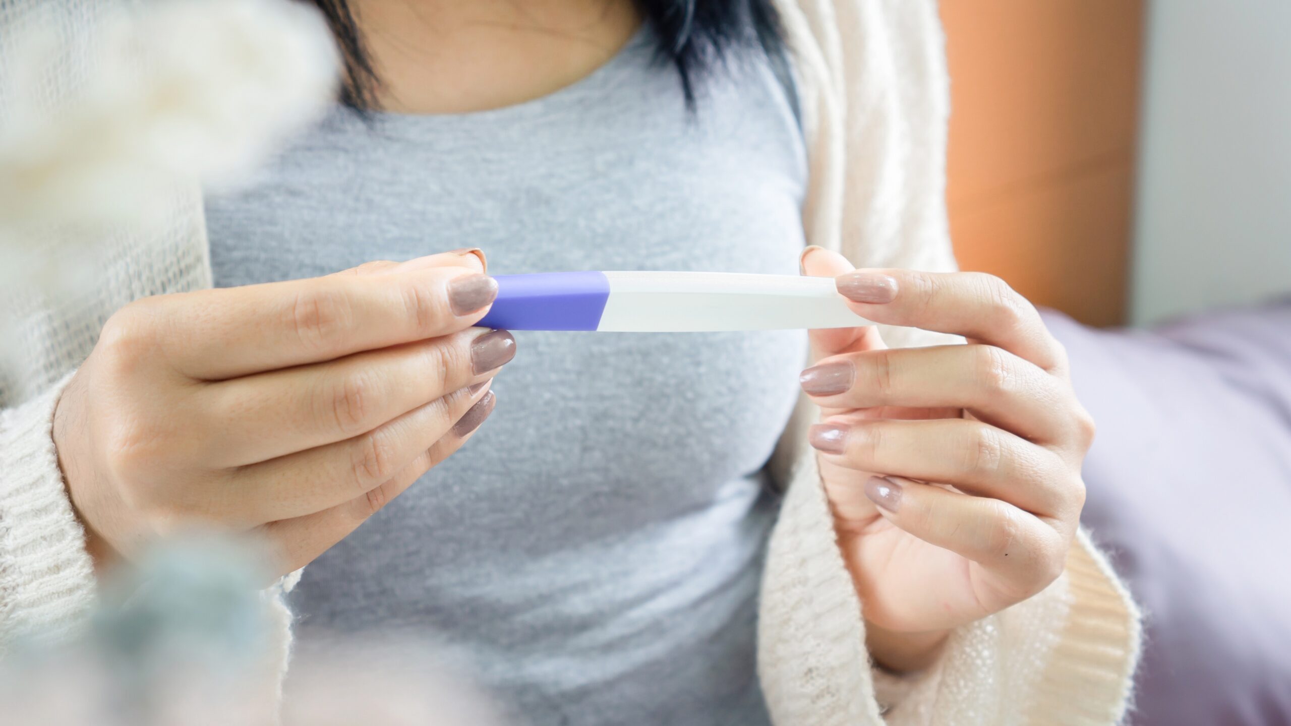 Woman holding pregnancy test