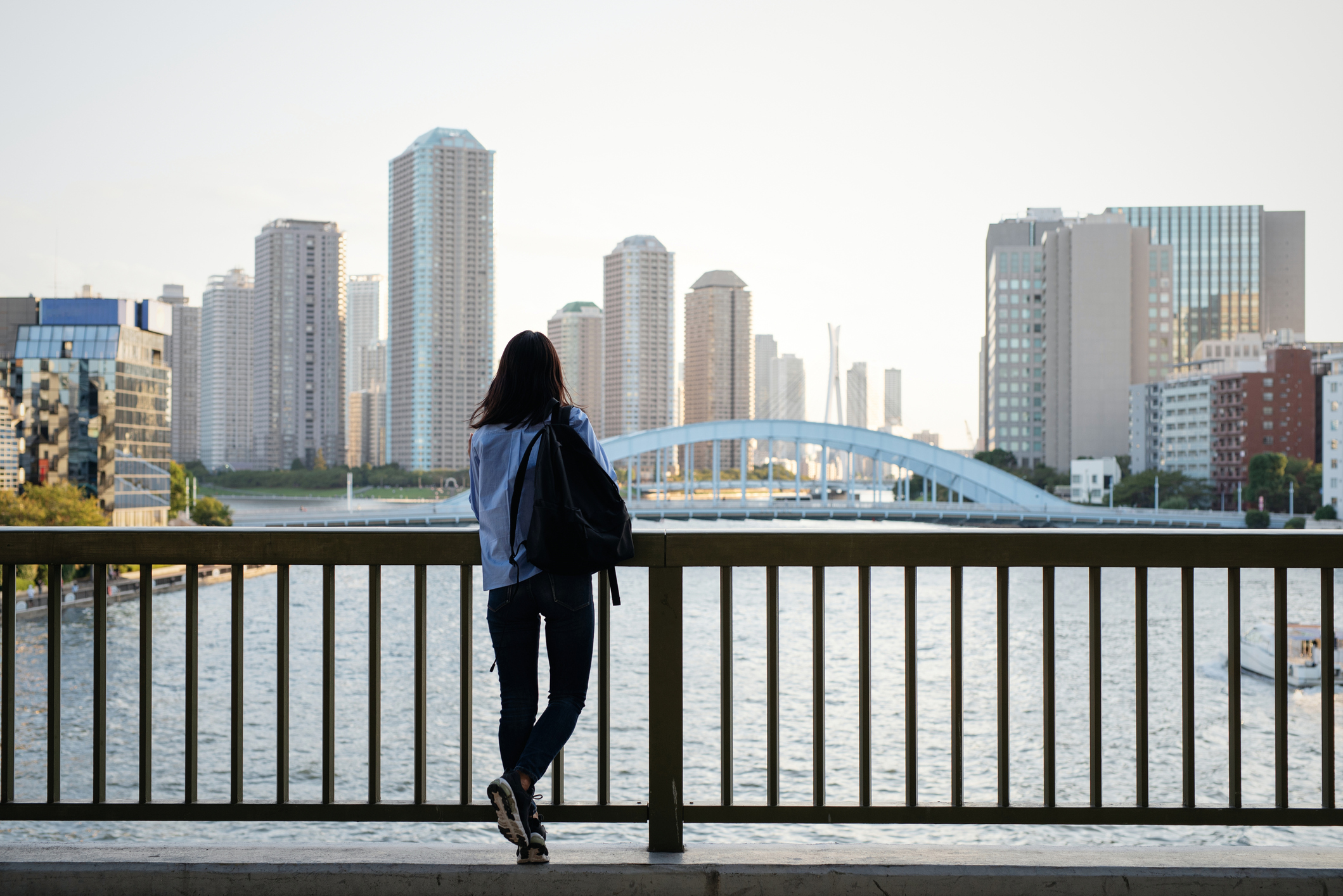 Rear view of woman looking at urban skyline