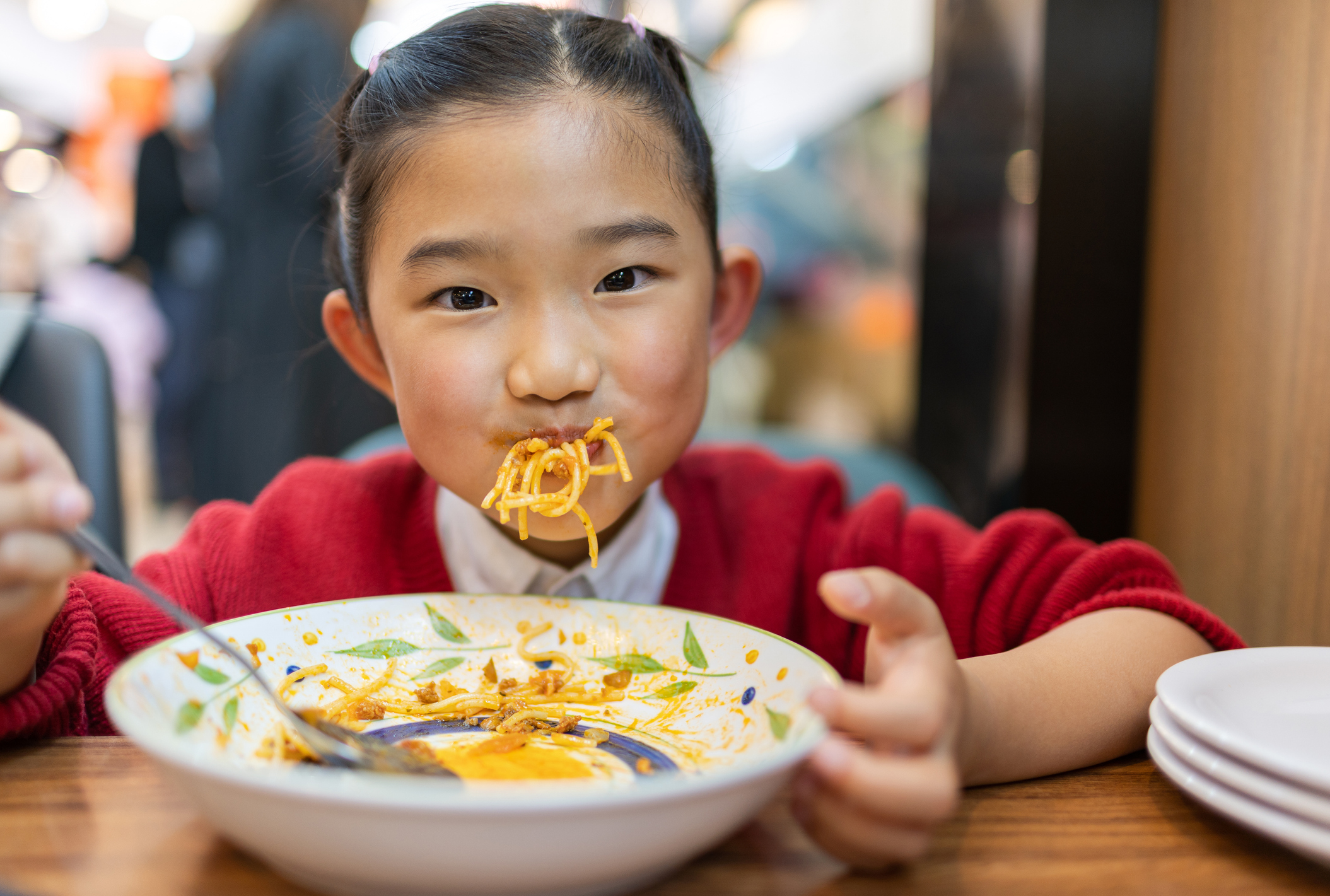 Little girl eating spaghetti