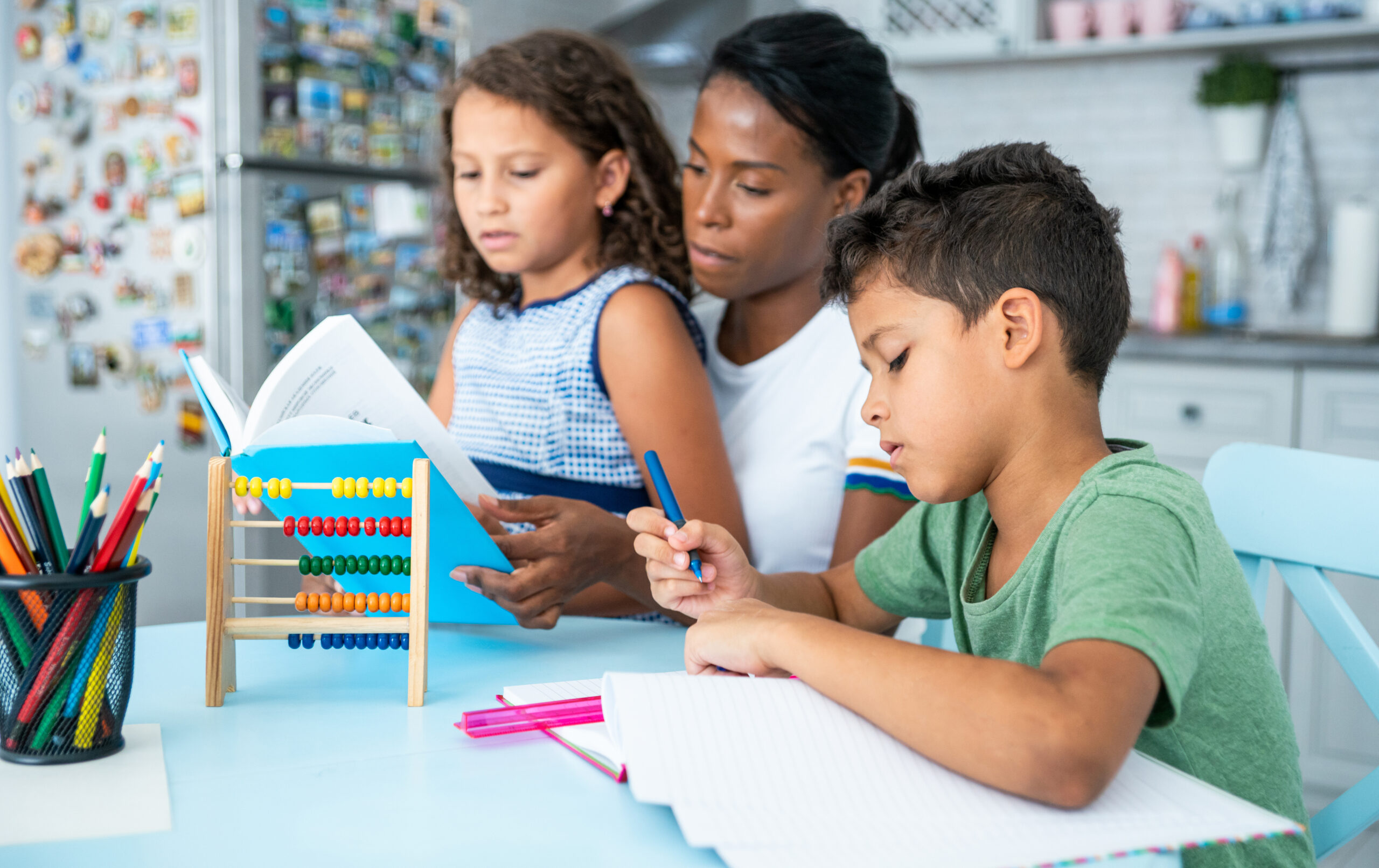 Mother helping her children while studying.