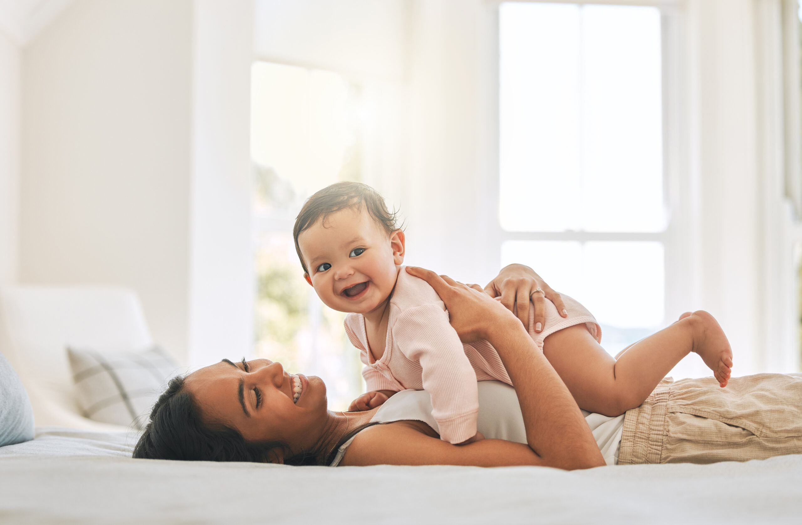 Cropped shot of an attractive young woman and her newborn baby at home