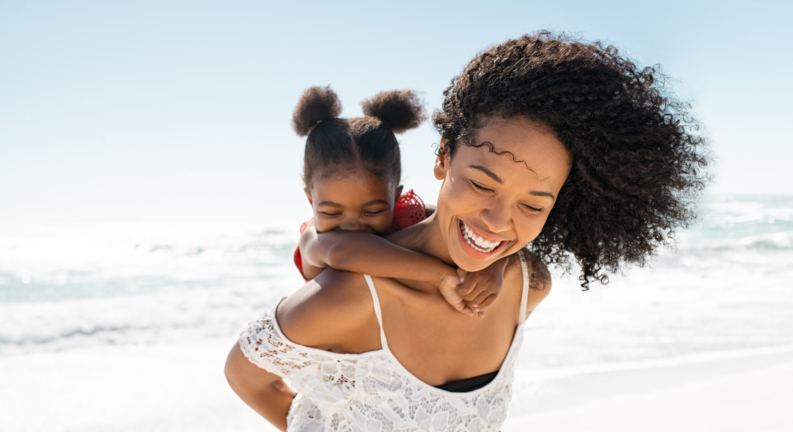 Mother and daughter having fun at beach