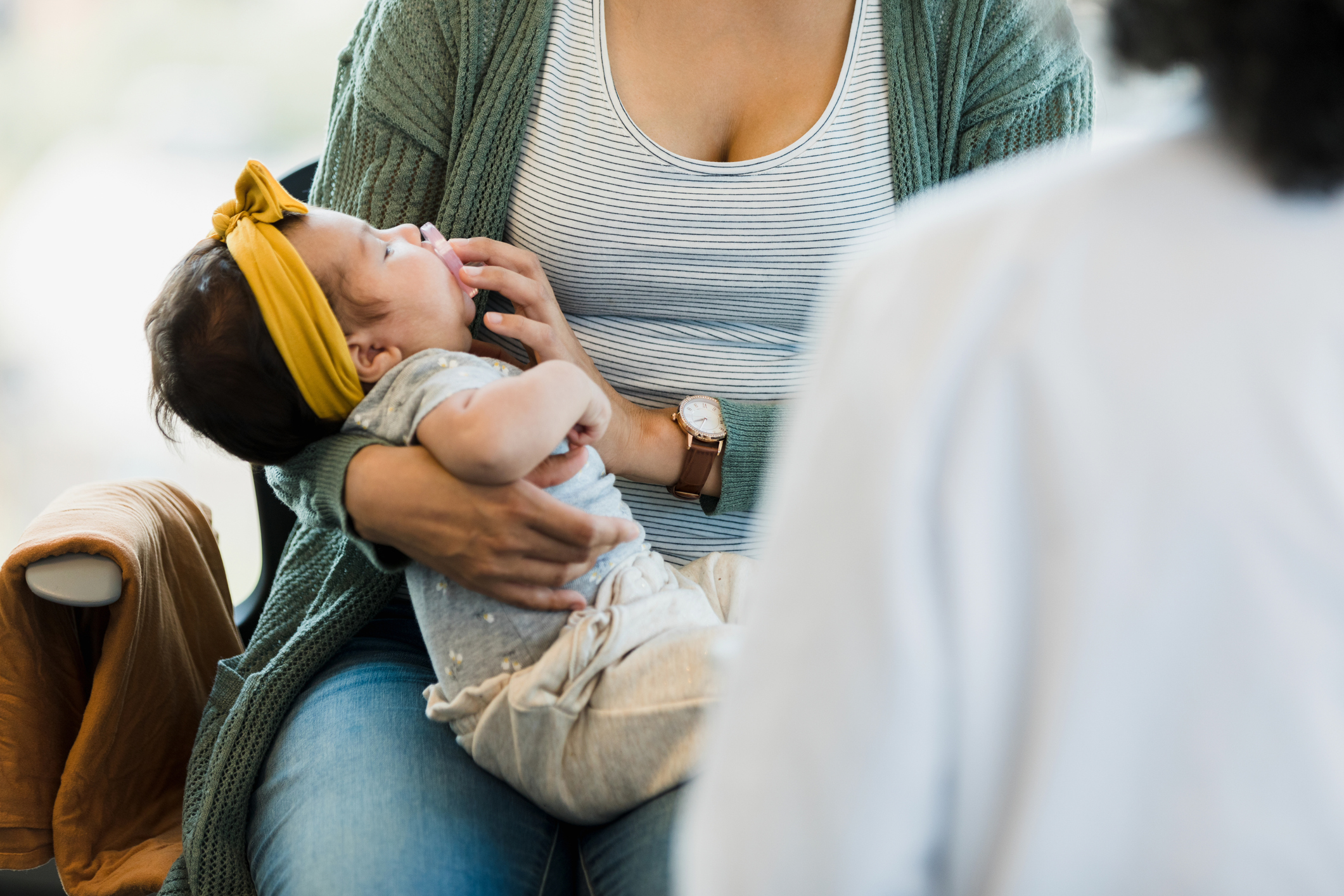 Unrecognizable person rocks baby to sleep