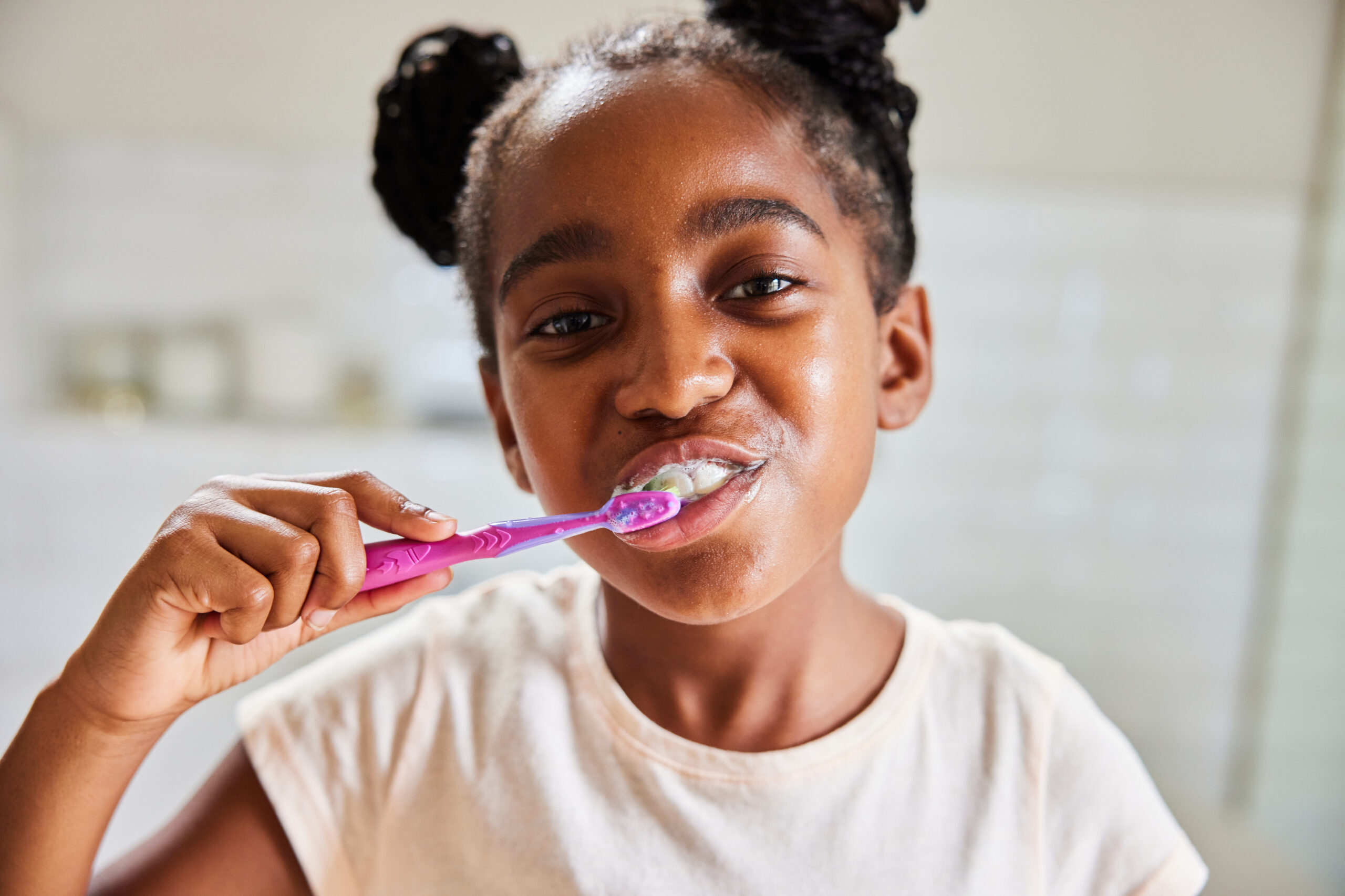 Cute little girl brushing her teeth in the morning