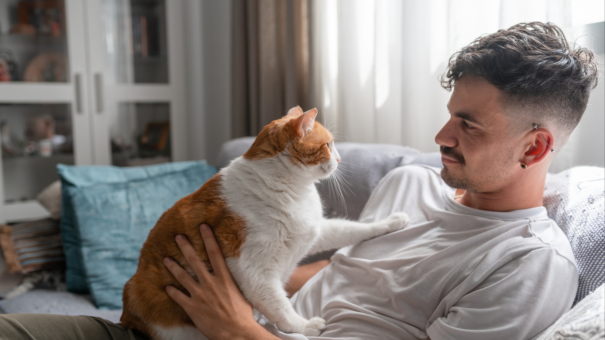 Man sitting on couch with cat