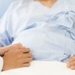 Pregnant woman in hospital bed