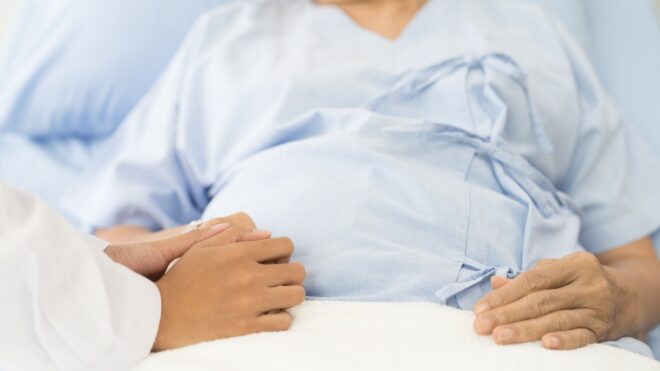 Pregnant woman in hospital bed