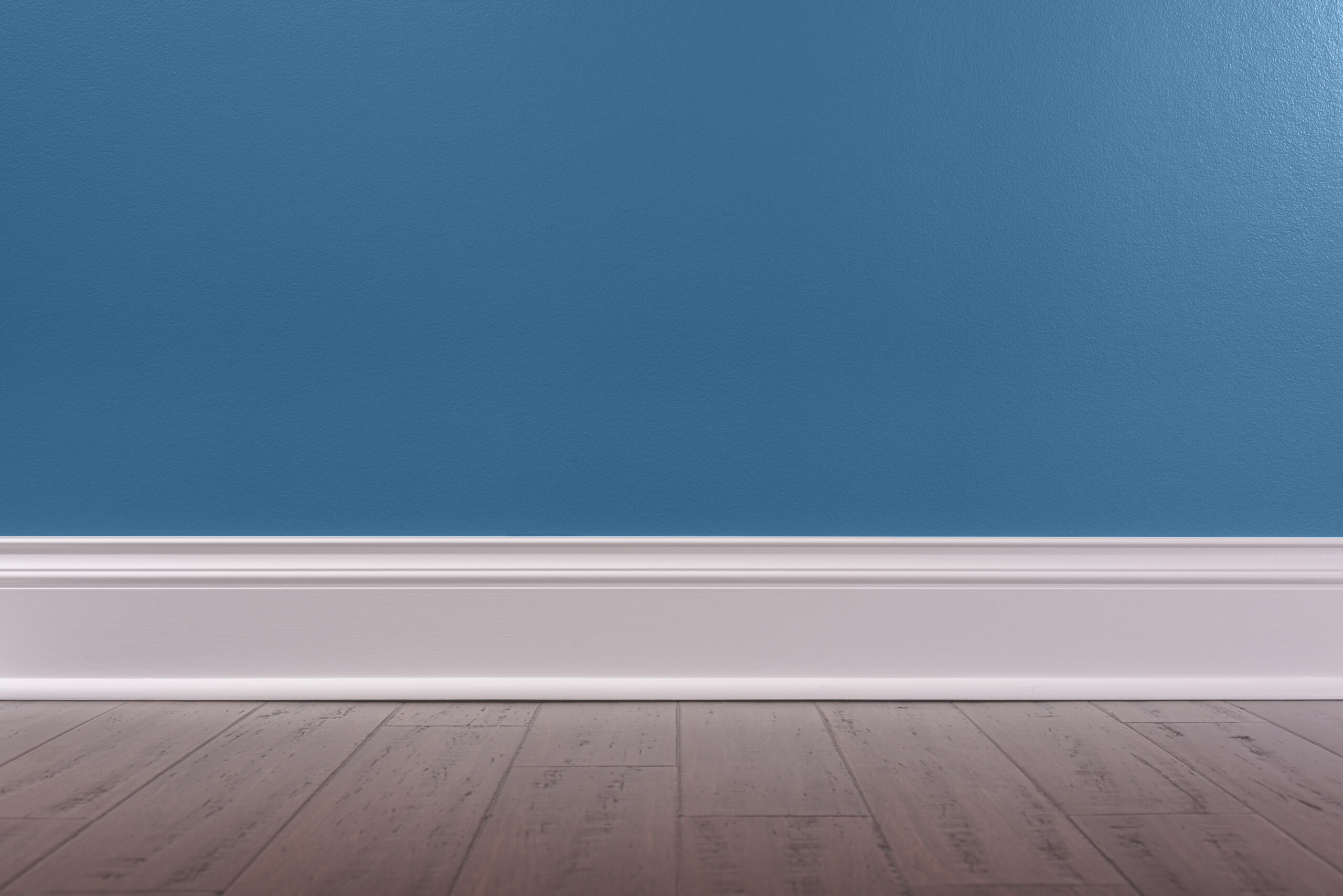 Empty room background with a blue wall, white baseboard and rustic wooden floor