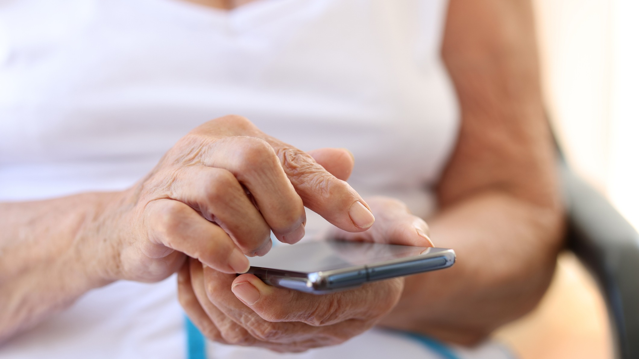 Elderly woman holding cell phone