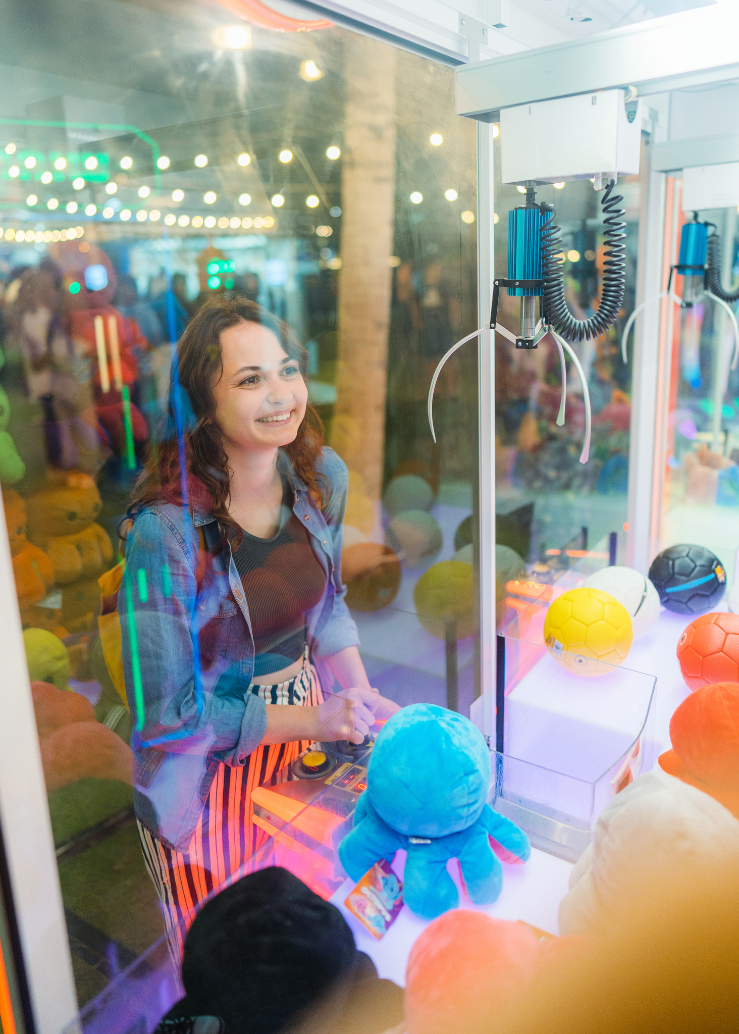 Woman playing on claw machine