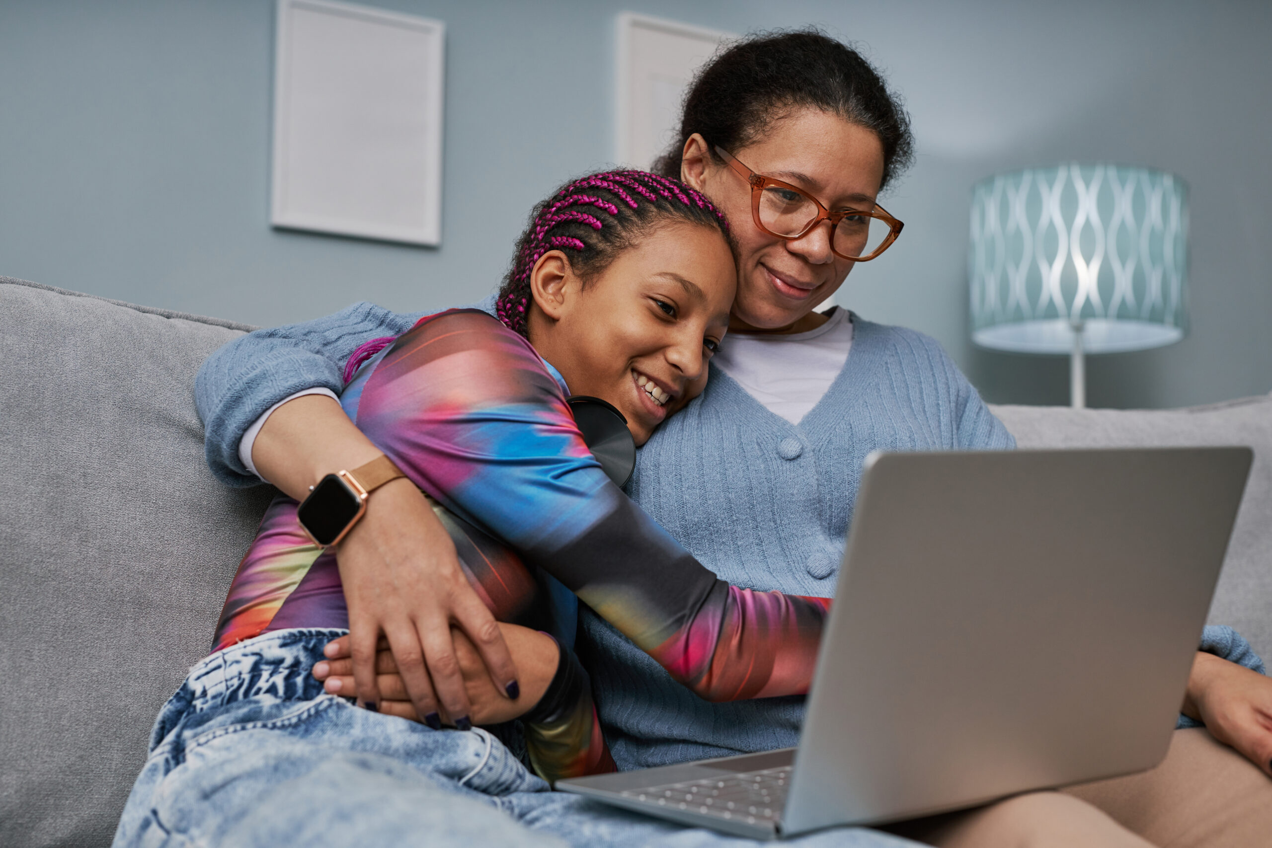 Mother and daughter using laptop together