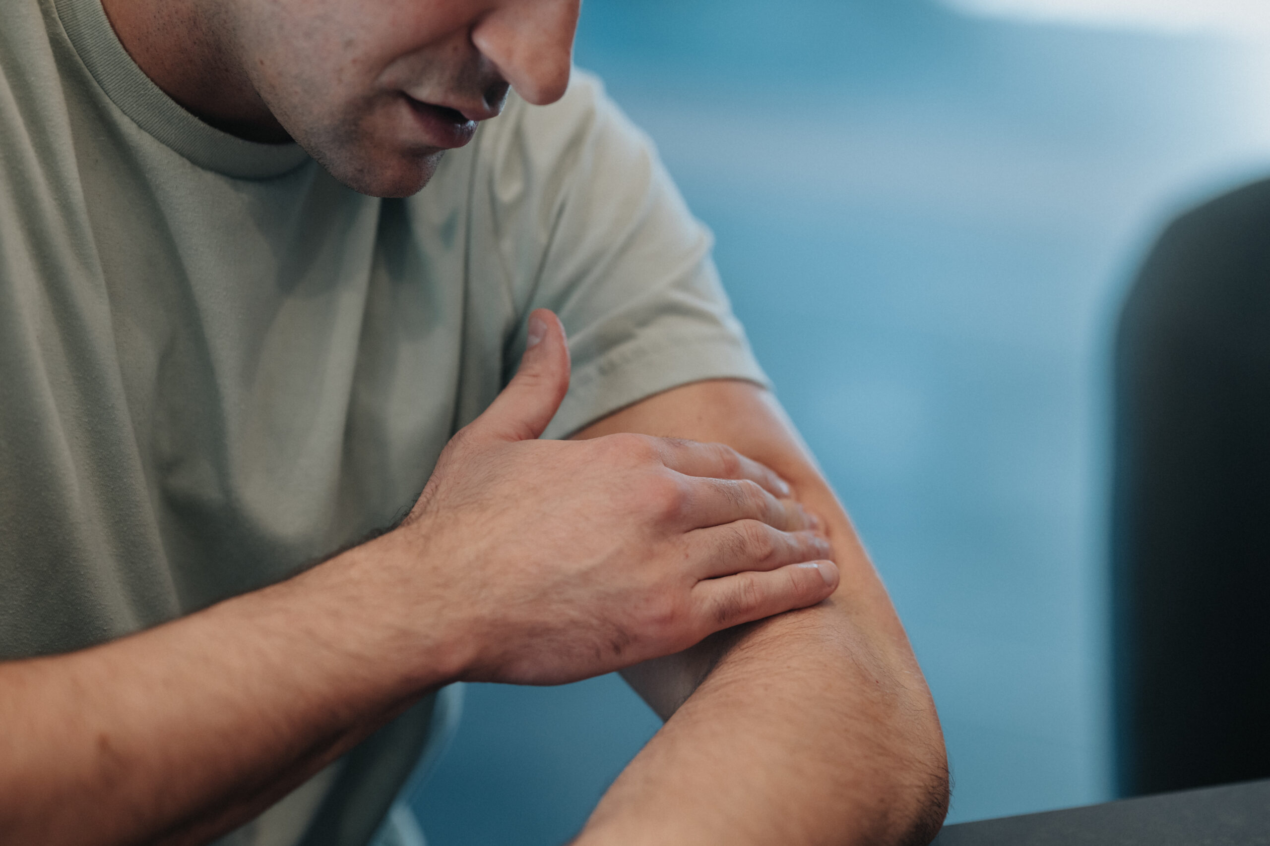 Unrecognizable man applying cannabis topical ointment for pain relief