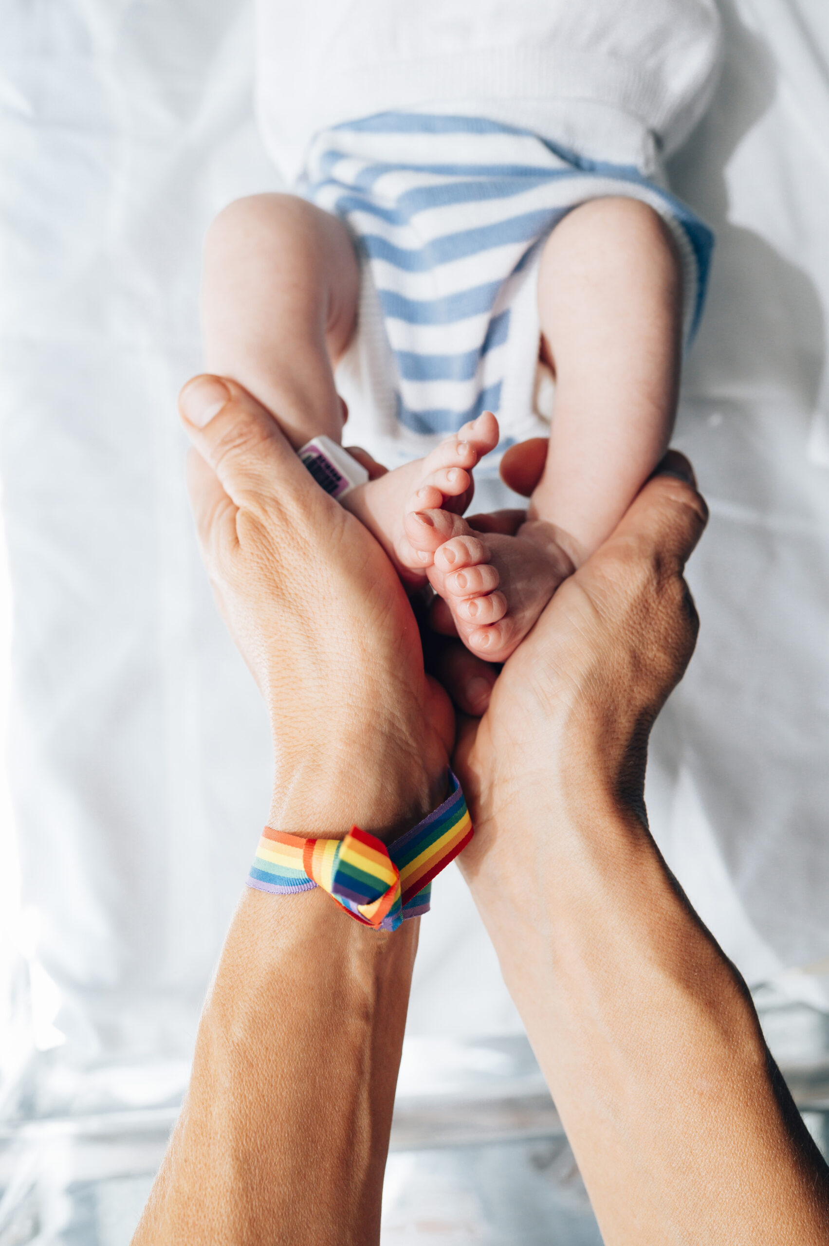 Hands holding the feet of a baby