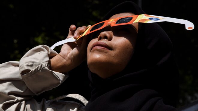 Girl watching solar eclipse