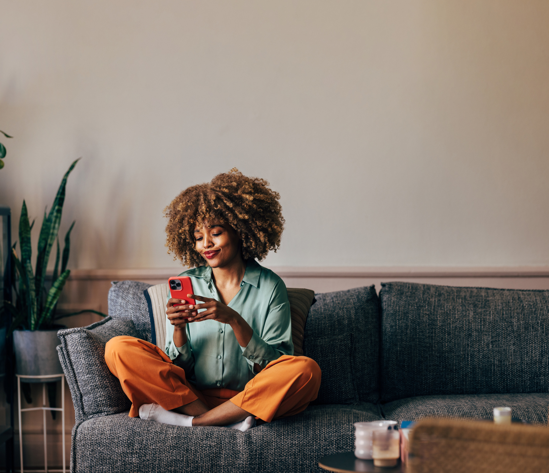 A Happy Beautiful Woman Texting On Her Mobile Phone While Relaxi