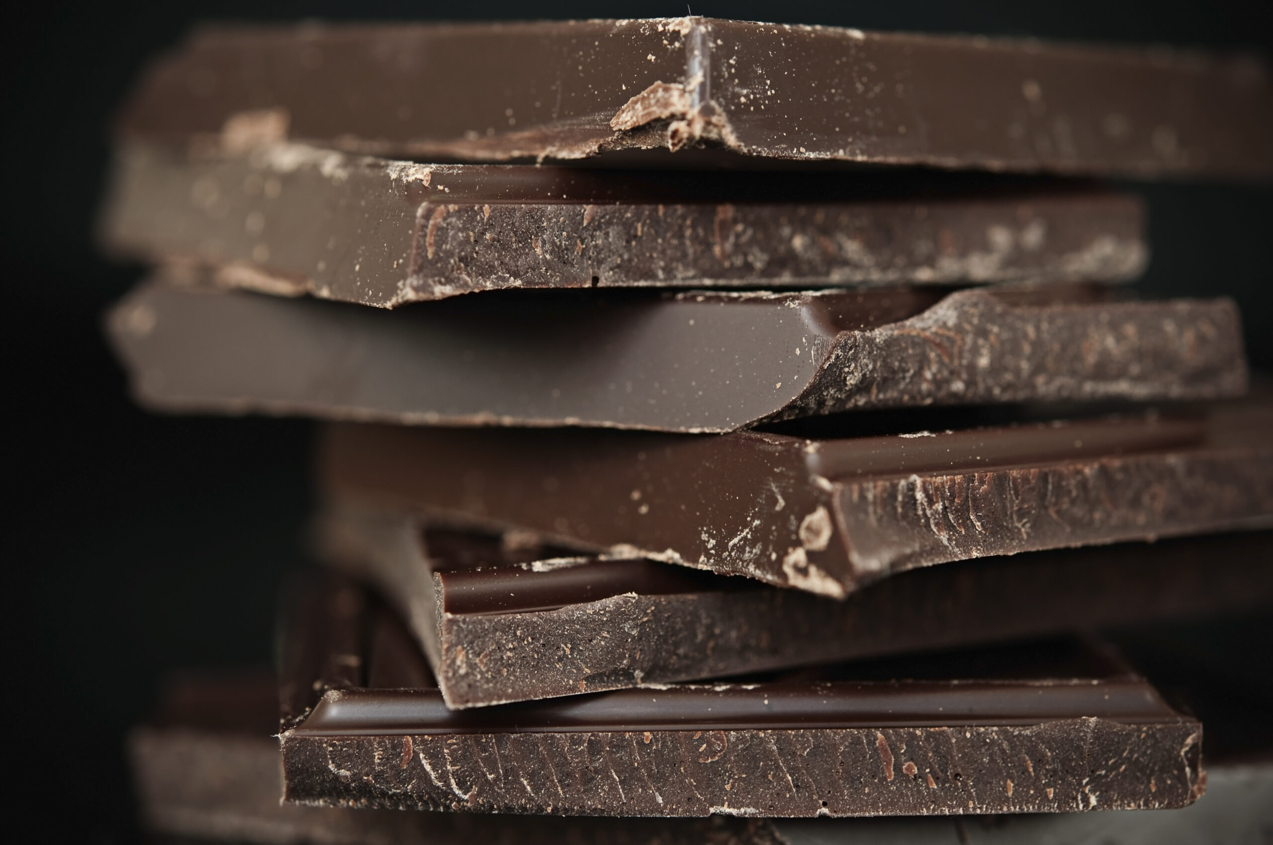 A close-up of a stack of dark chocolate