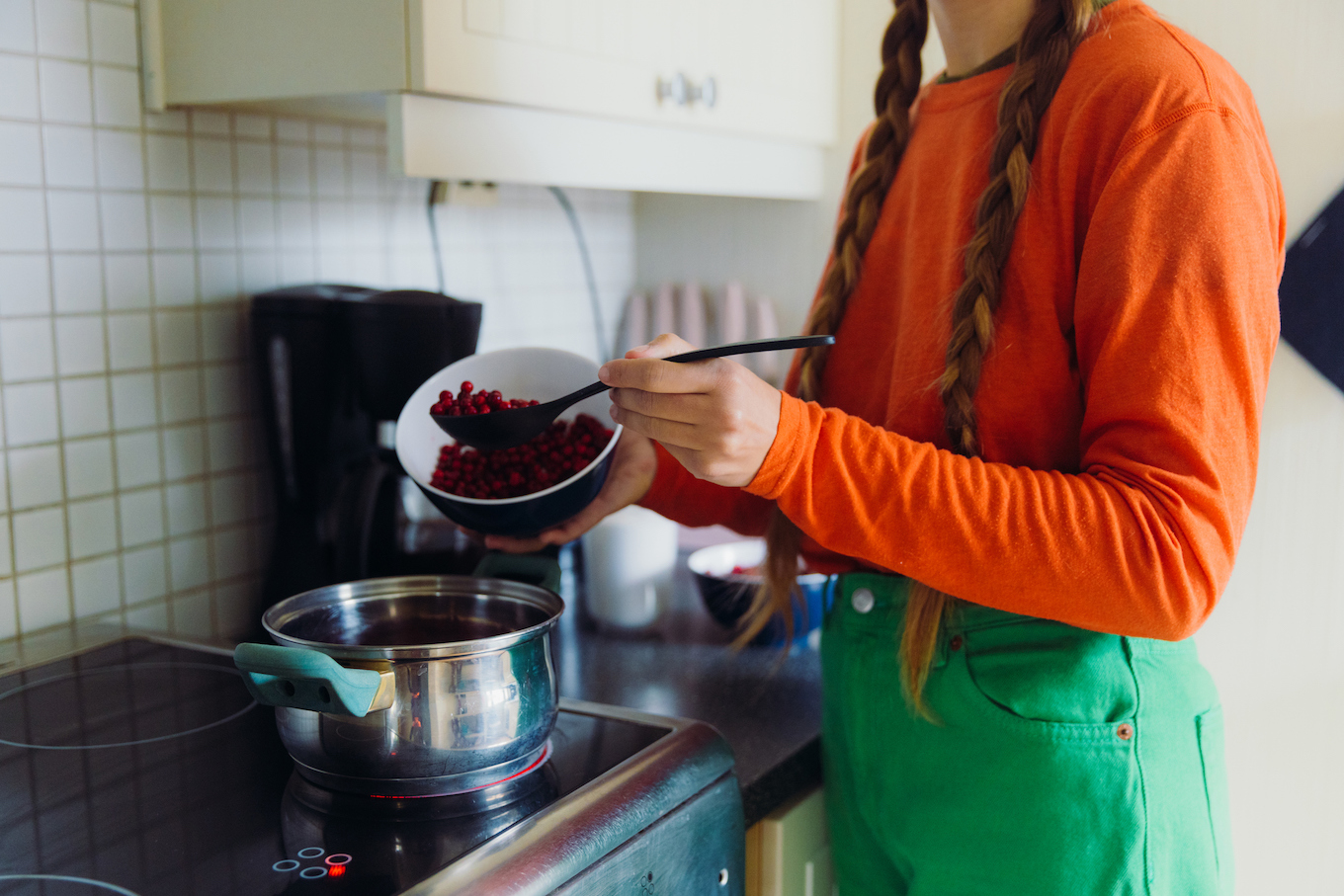 Woman Preparing Lingonberry Jam in Kitchen