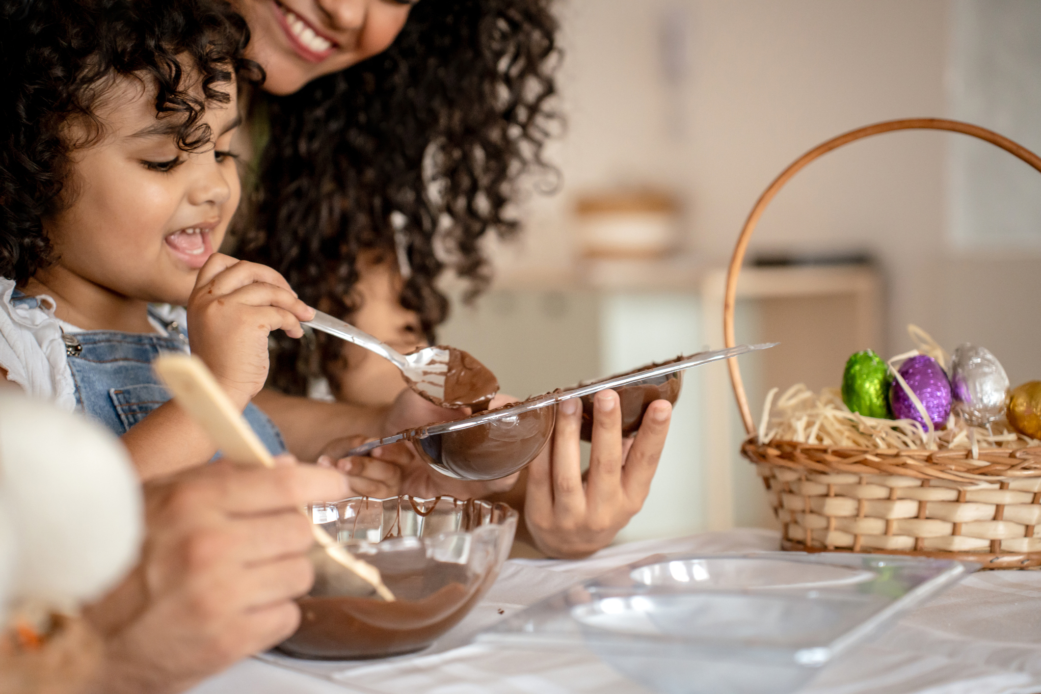 Family with a daughter making chocolate for Easter