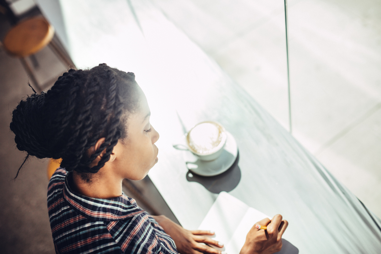 Journaling Woman with Coffee in Cafe