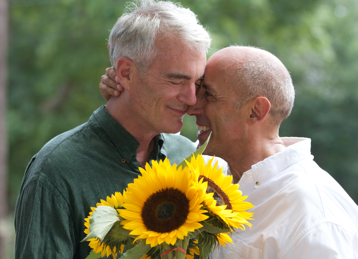 Senior Gay Male Couple with Sunflowers at Flower Stand