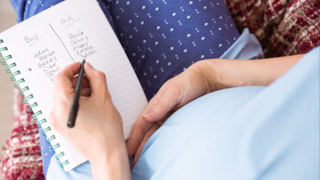 Woman writing down boy and girl names